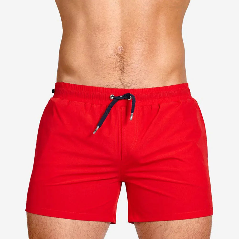 Men's solid colour mesh lining sports shorts for swimming and fitness in polyester fabric