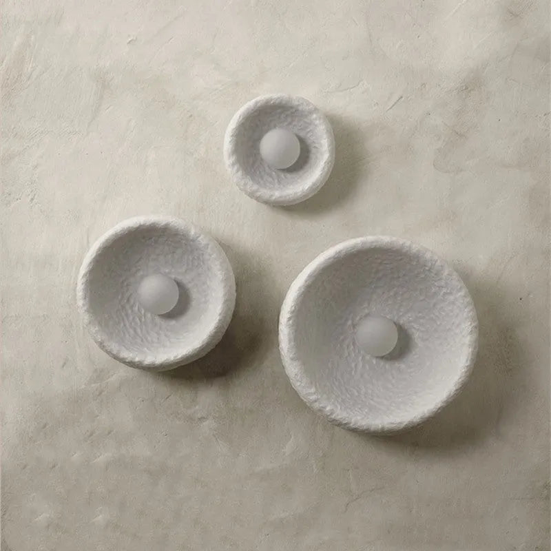 Japanese-style wall lamp with resin shade in three diameter sizes on white wall