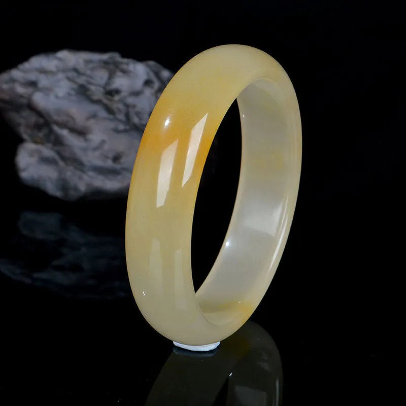 Natural light jade Chinese style bracelet on a white background showing polished finish.