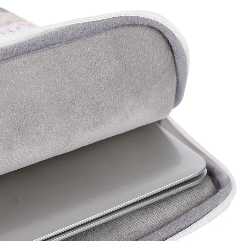 White waterproof PU leather laptop sleeve for 11 to 15 inch computers on a table.