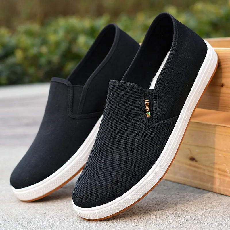 Men's black slip-on canvas shoes with round toe and composite sole