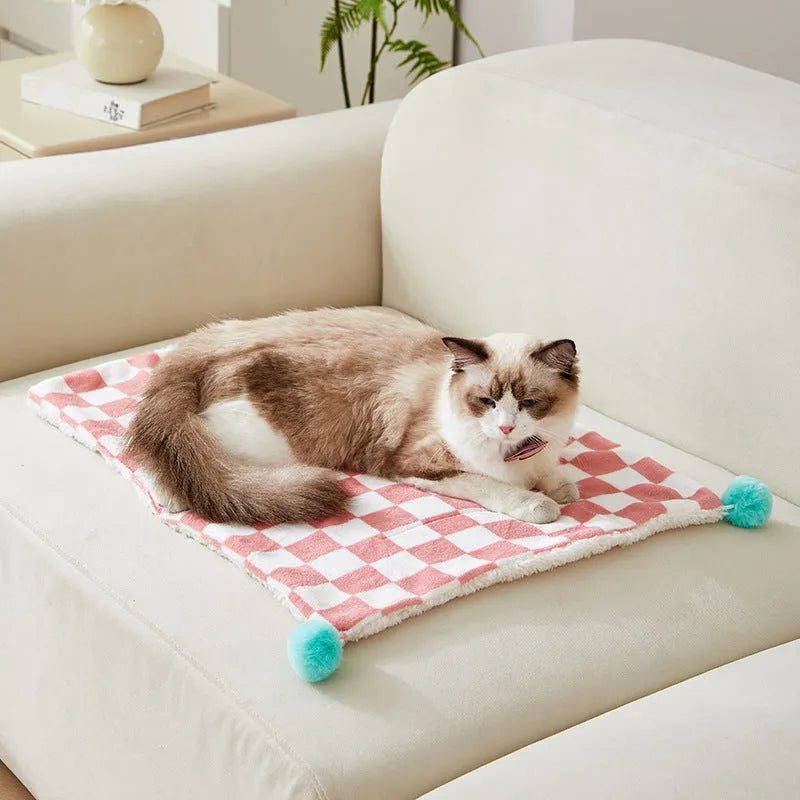 Plaid pattern pet blanket with fur ball trim on soft cotton fleece material for cats and dogs