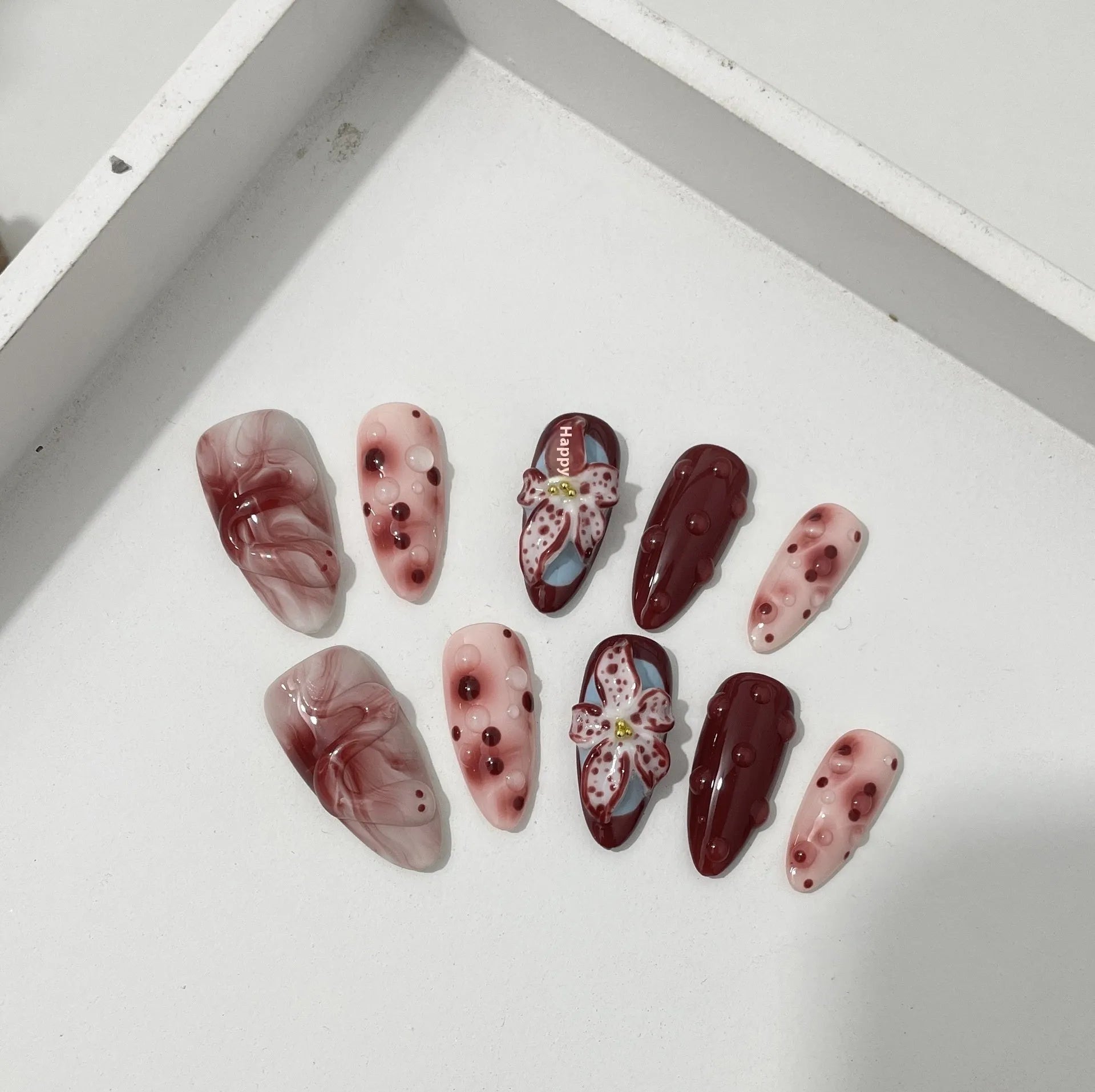 Hand-painted 3D carved manicure nails in almond colour with rose and tulip floral patterns