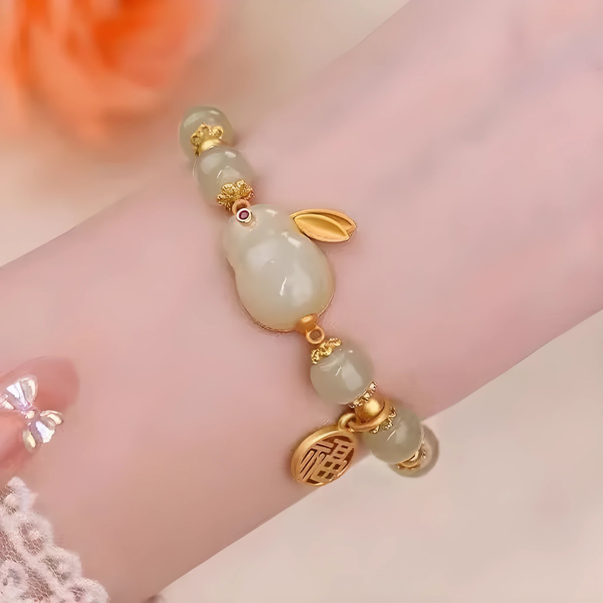 Green jade women's bracelet with a sculpted hare charm, engraved Fu character, and lily detailing
