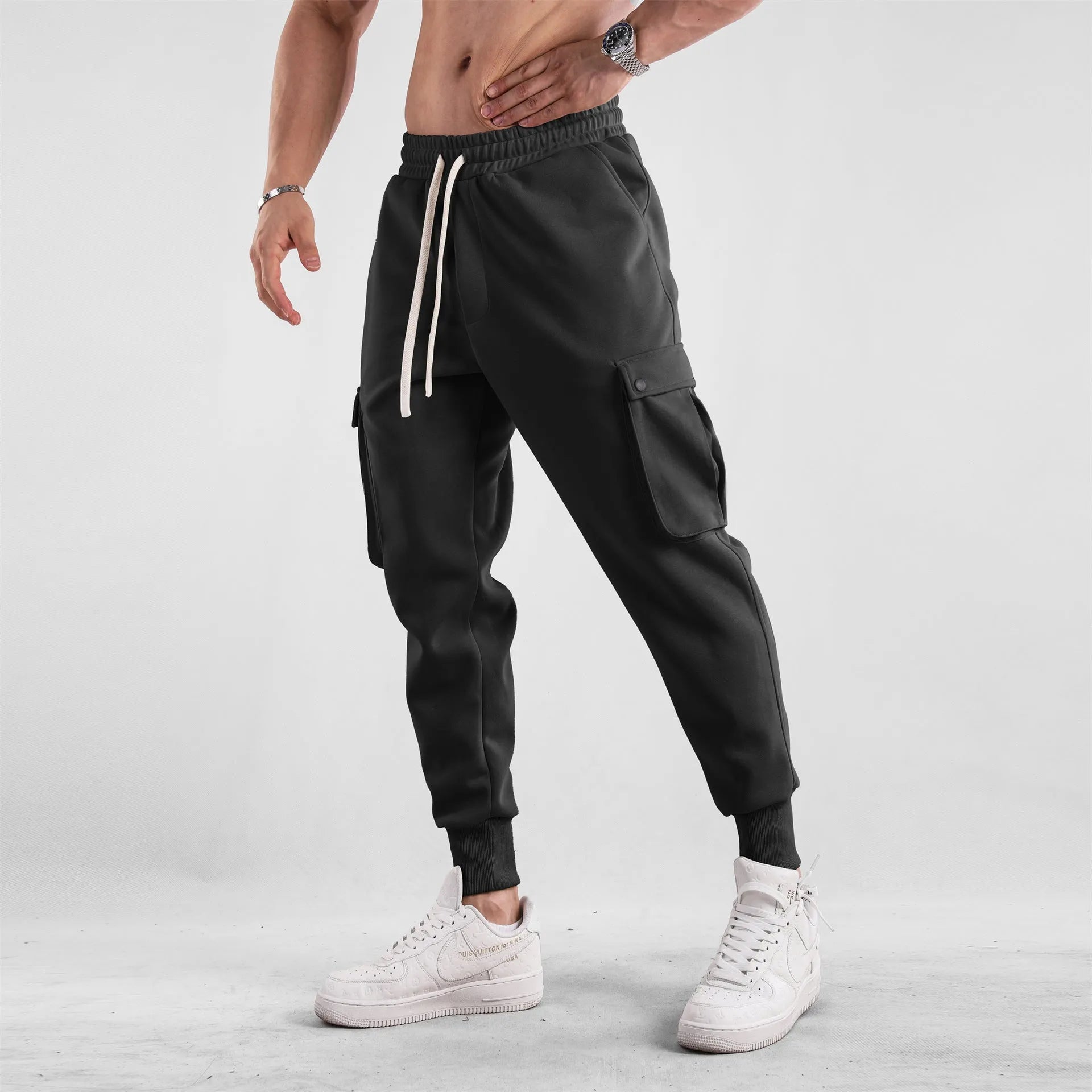 Men's loose light gray cotton trousers with ankle-tied cuffs and multiple pockets