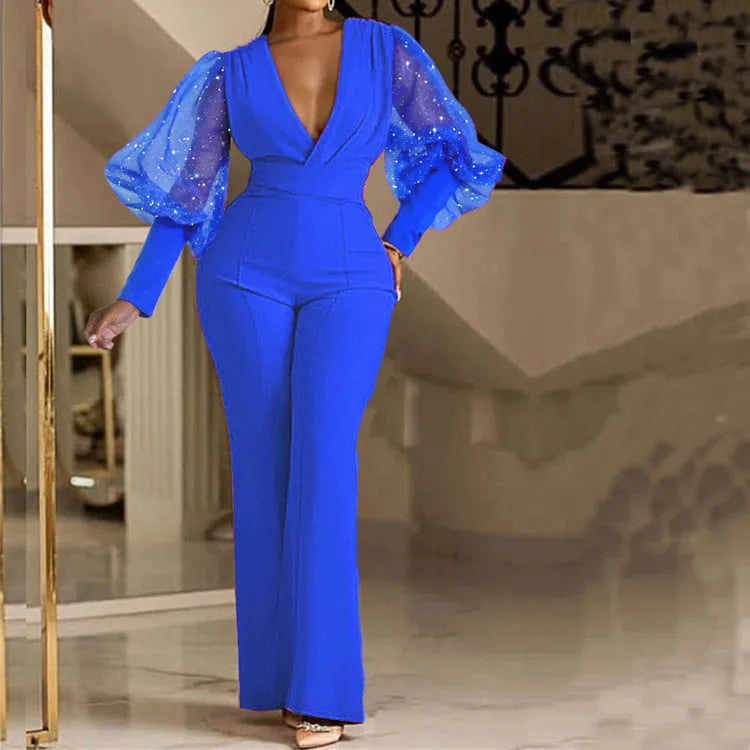 Red women's long sleeve jumpsuit with mesh stitching detail, elastic waist, and wide leg trousers.