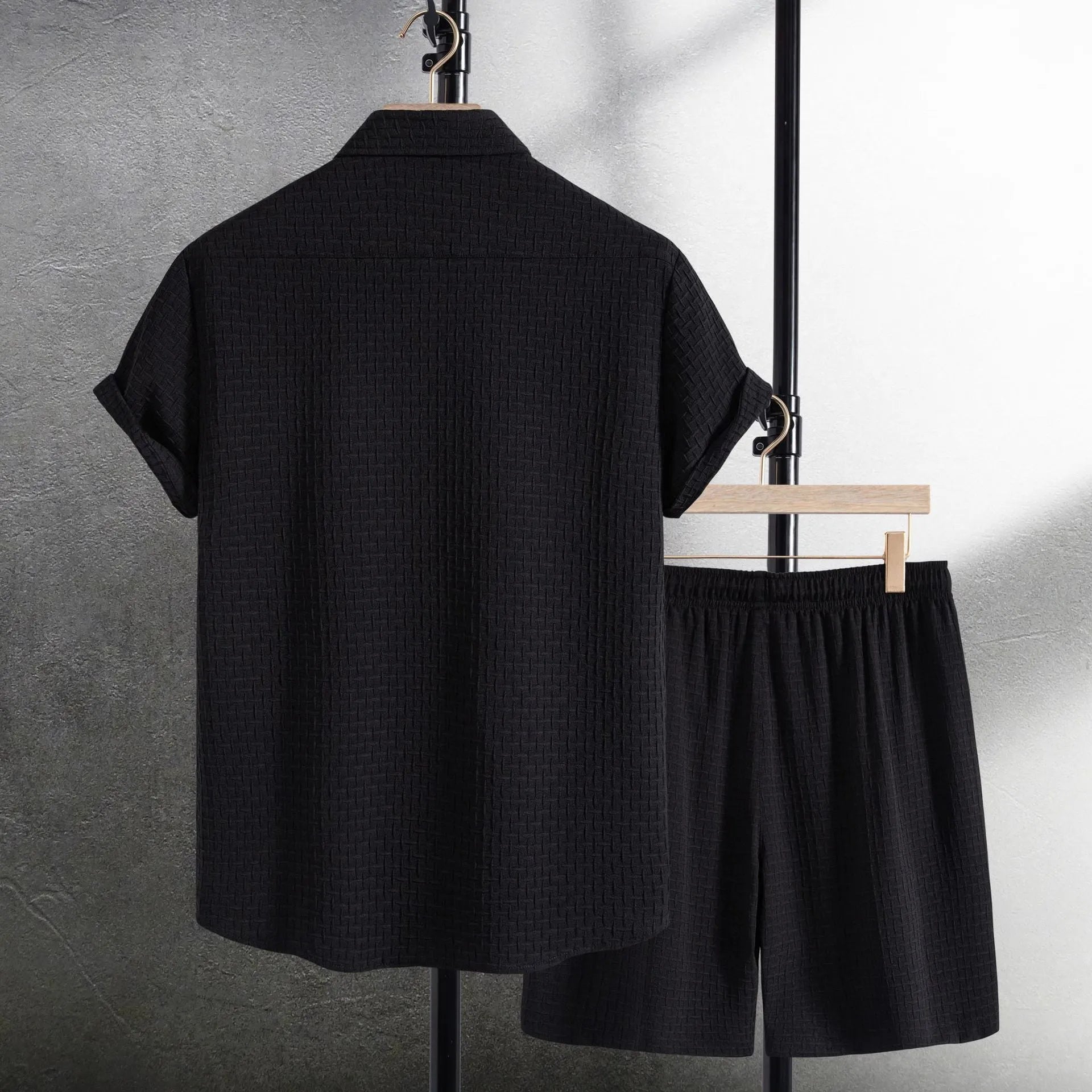 Men's black cotton blend short sleeve shirt and shorts casual suit set on a hanger.