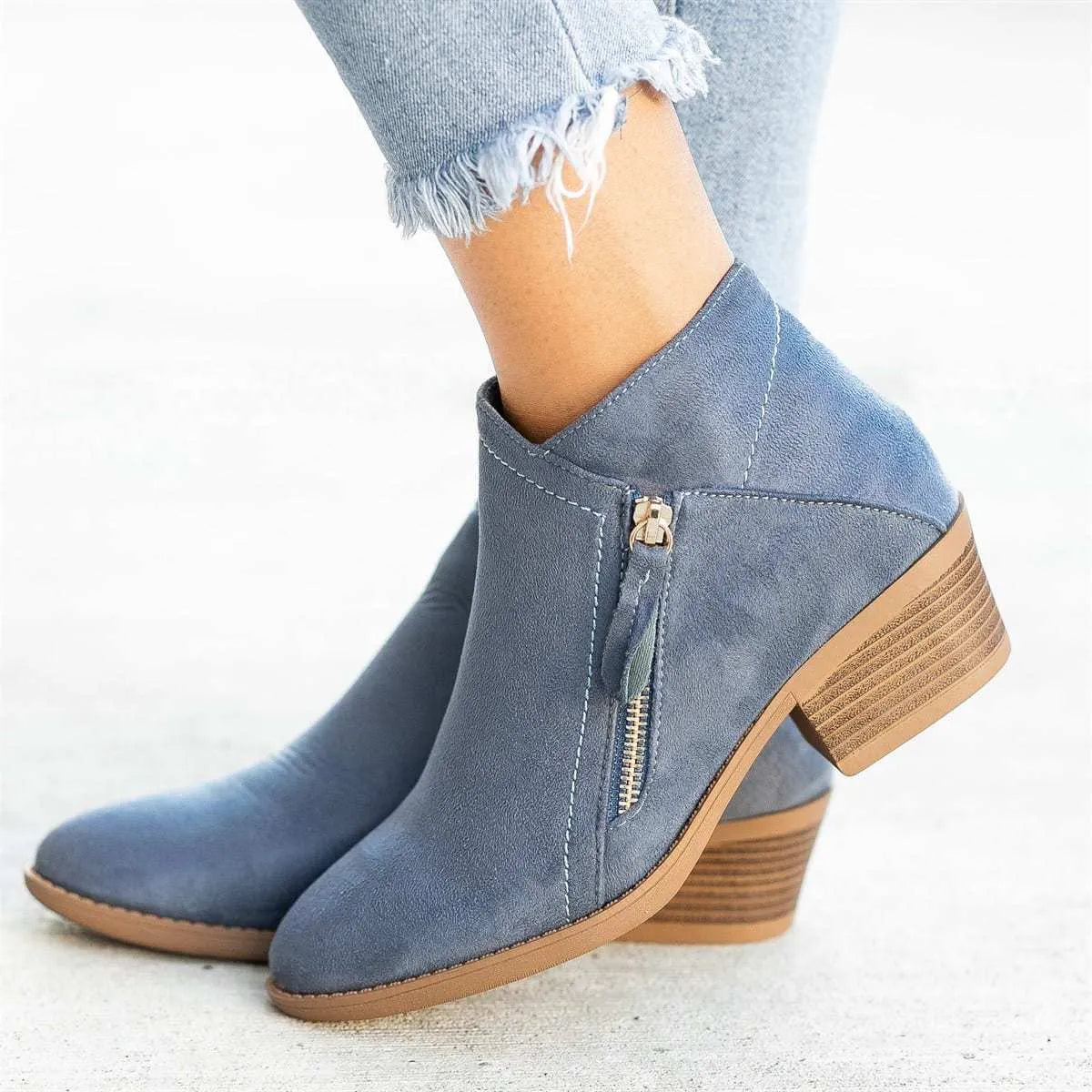 Women's beige suede chunky heel ankle boots with a side zip fastening, shown on a neutral background.