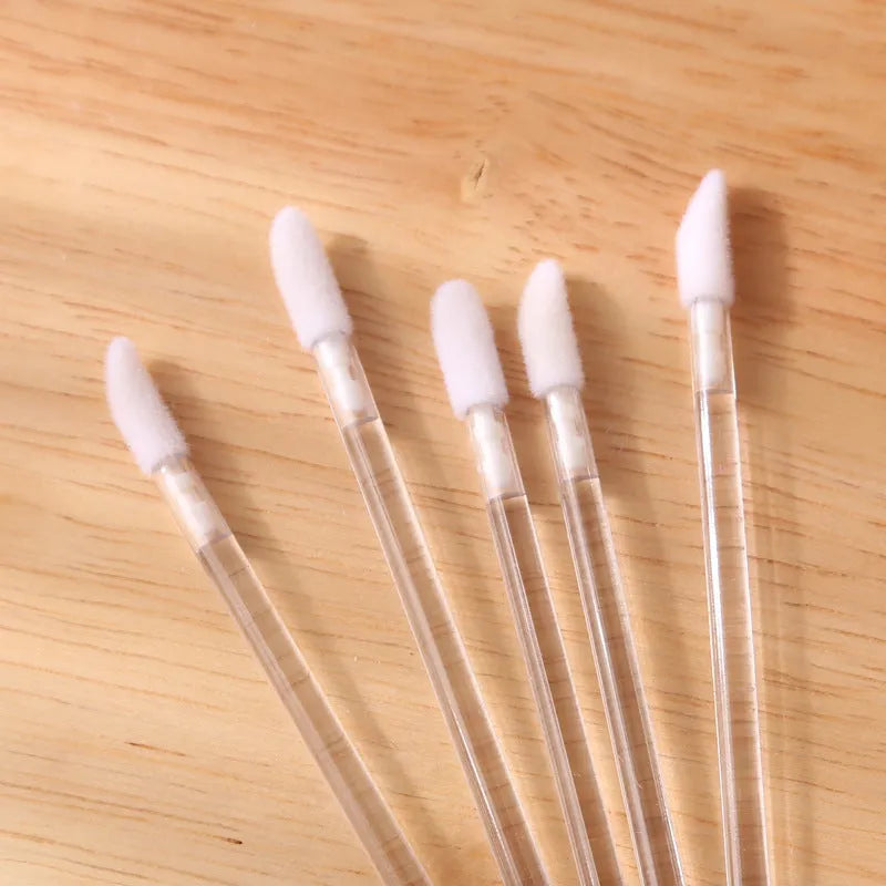 Disposable lip brushes with flocked heads and black handles in various colours