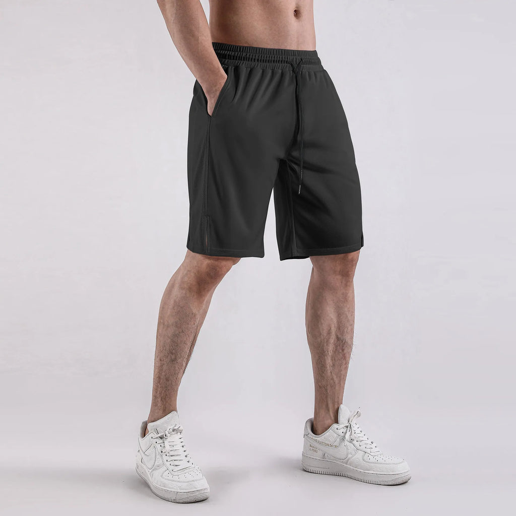 Man wearing black quick-dry mesh fitness shorts with a loose, casual fit and elasticated waistband.