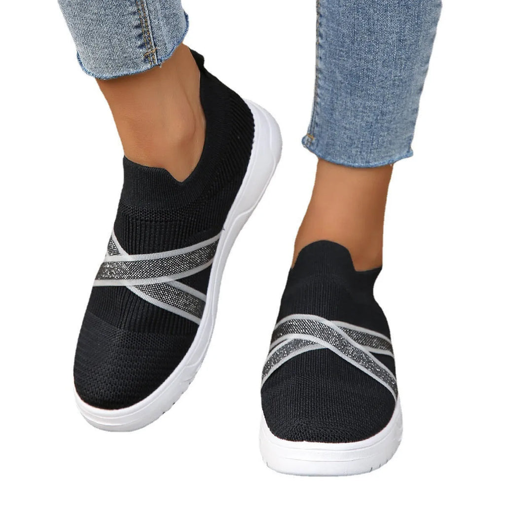 Black women's flat knit mesh shoes with tassel detail and rubber sole
