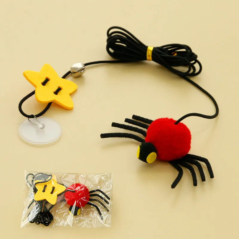 Red cat door hanging toy with elastic rope, feathers, bell, and spider attachments for interactive play