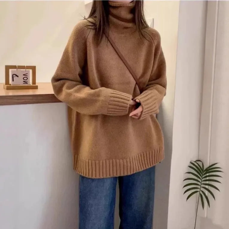 Women's loose-fit turtleneck sweater with a thick, textured curling pile collar in a grey solid colour.