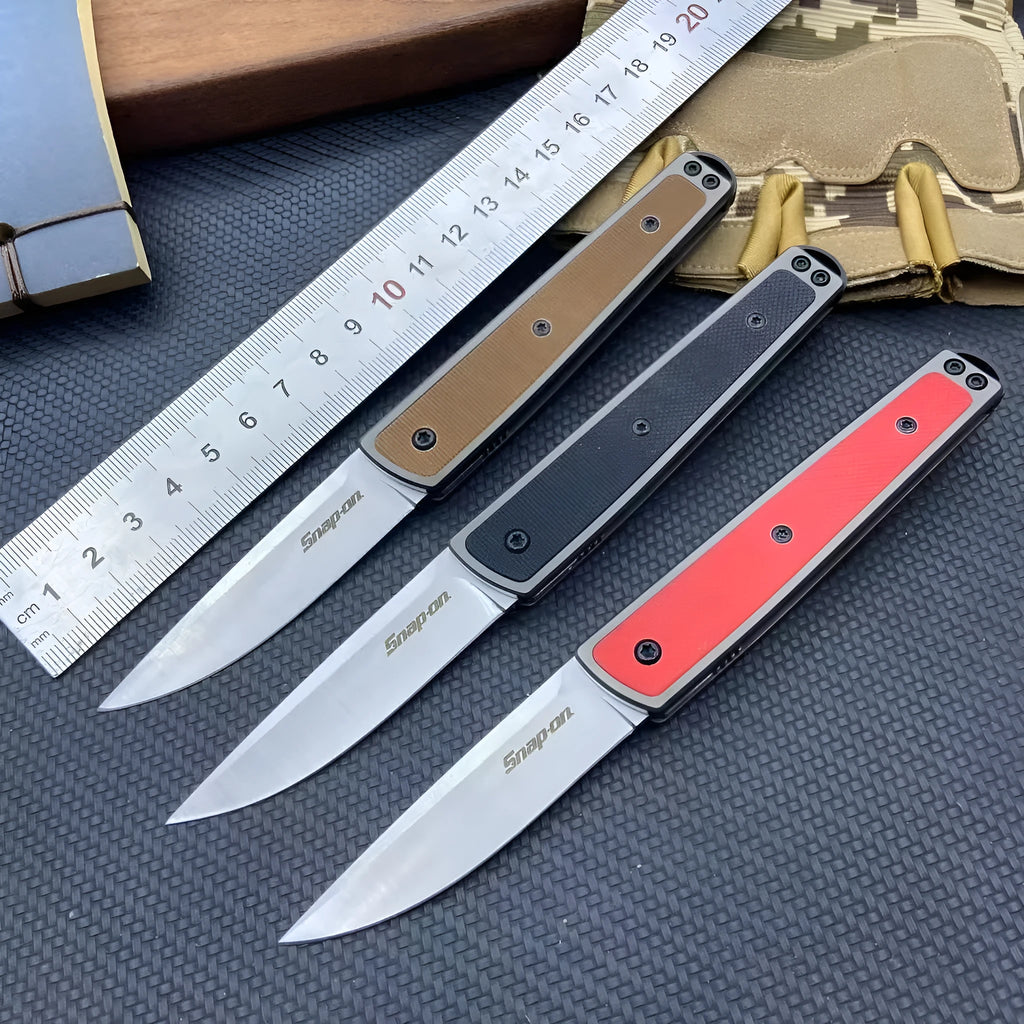 Folding fruit knife with stainless steel blade in black, brown, or red colour options showing closed and open positions