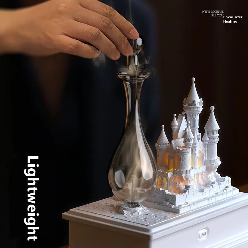 White medieval castle waterless aromatherapy machine with USB charging cable and essential oil