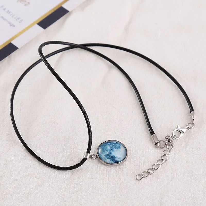 Alloy necklace with luminous glass pendant showing Christmas moon night sky and constellation design.
