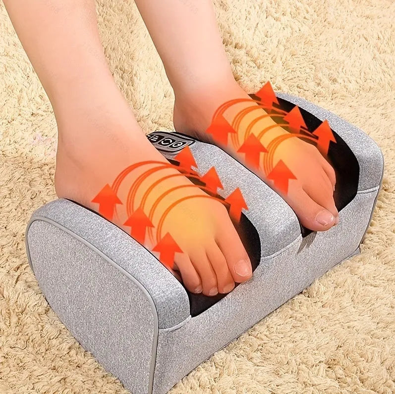 Automatic foot massage machine in gold colour with remote control on a wooden floor.