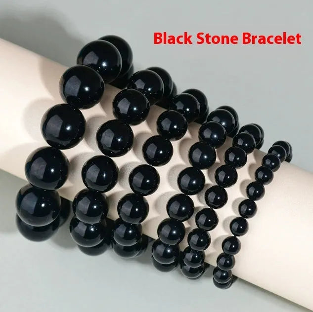 Hand-woven round obsidian bead bracelet in multiple colour options on a wrist.