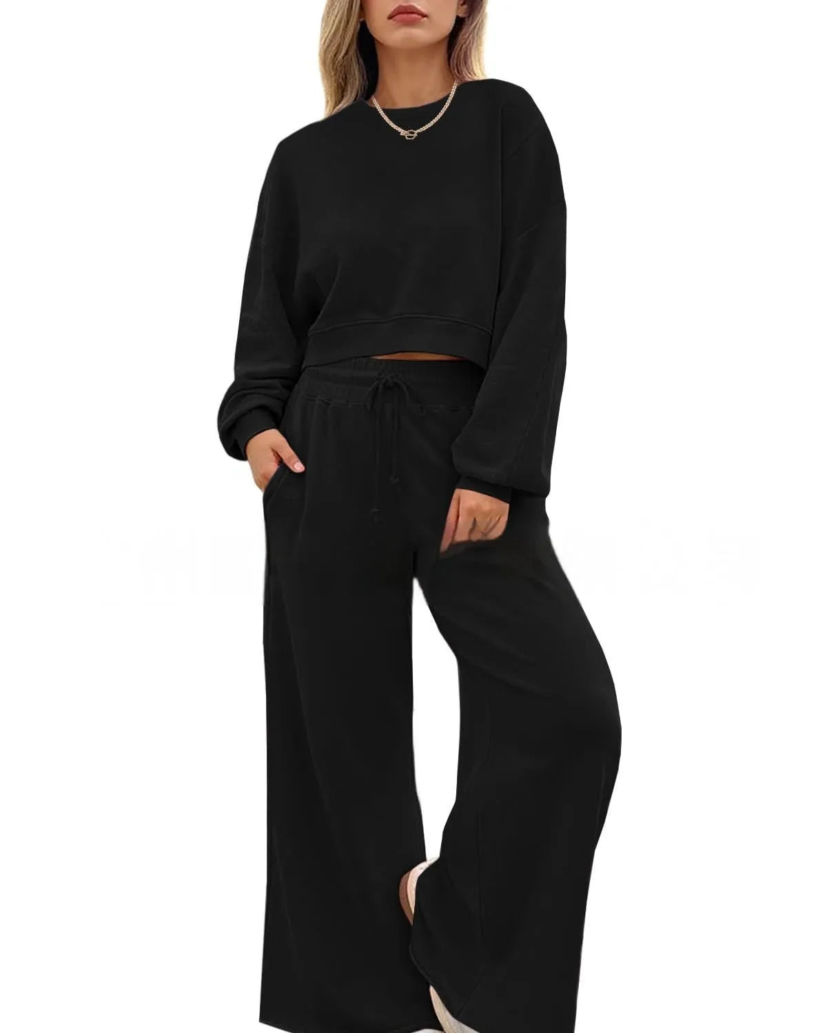 Women's solid colour long sleeve top and trousers two-piece set in polyester fabric.