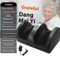 Automatic foot massage machine in gold colour with remote control on a wooden floor.