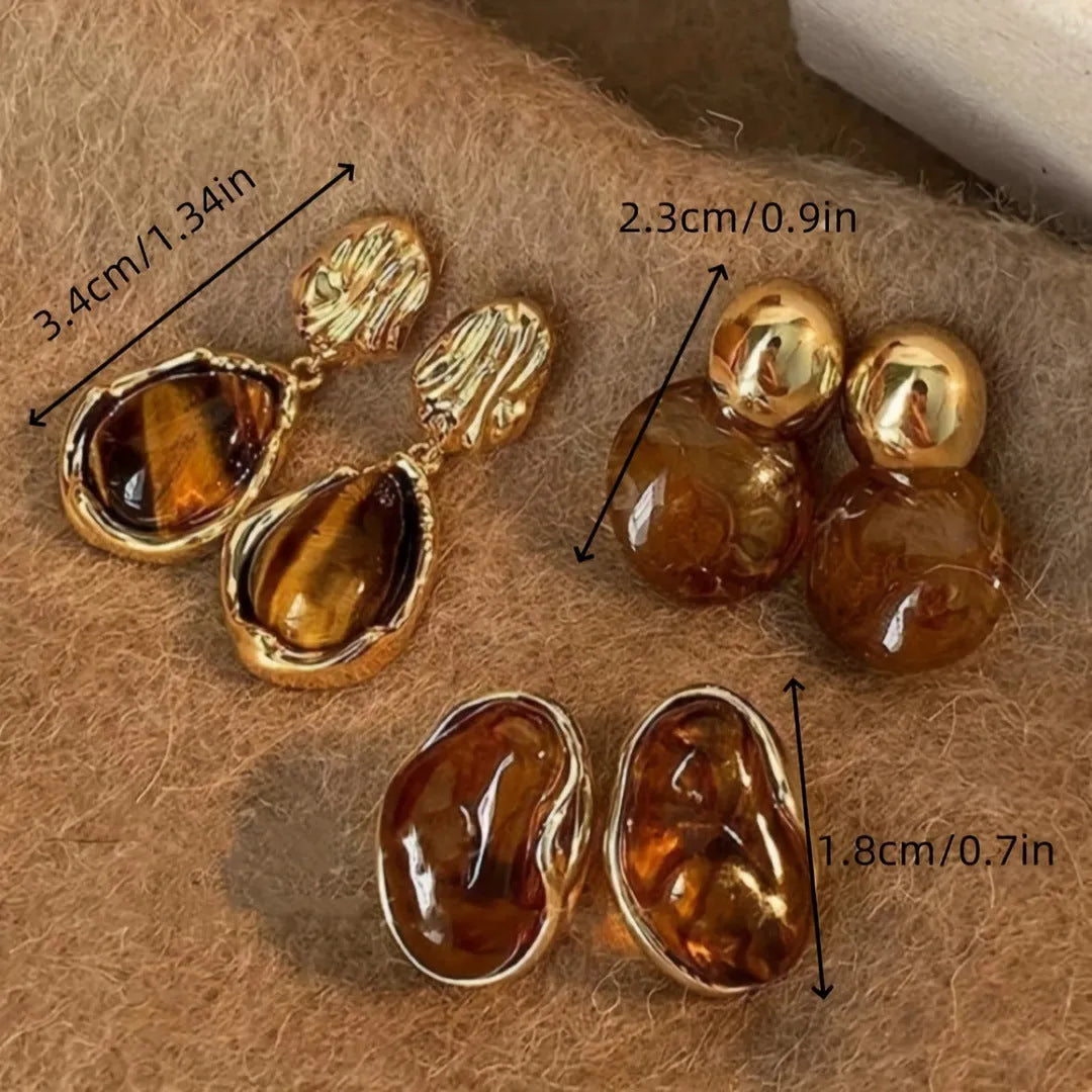 Three pairs of geometric alloy ear rings with tassel elements in different electroplated finishes