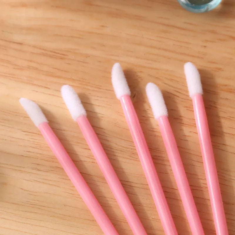 Disposable lip brushes with flocked heads and black handles in various colours