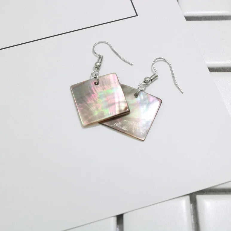 Women's geometric shell earrings in square panther or rectangular shell designs with natural material texture