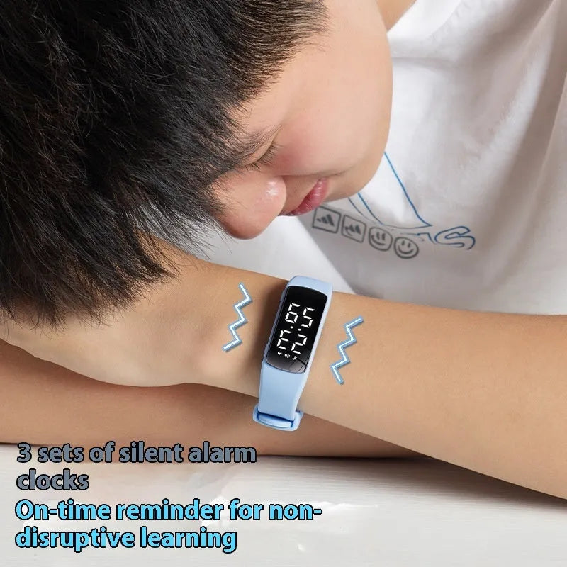 Black vibration alarm smart watch with LED display and silicone strap on a wrist.