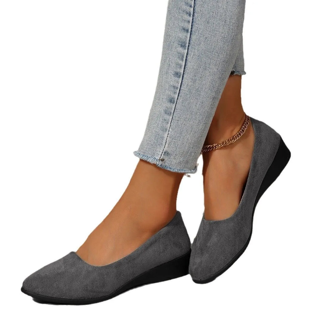 Women's suede wedge pumps in light brown colour showing shallow mouth design and low wedge heel