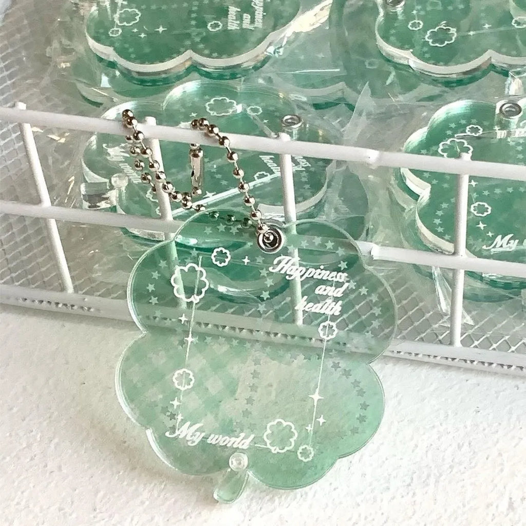 Acrylic four-leaf clover pendant charm for phone or keychain in blue or green colours.