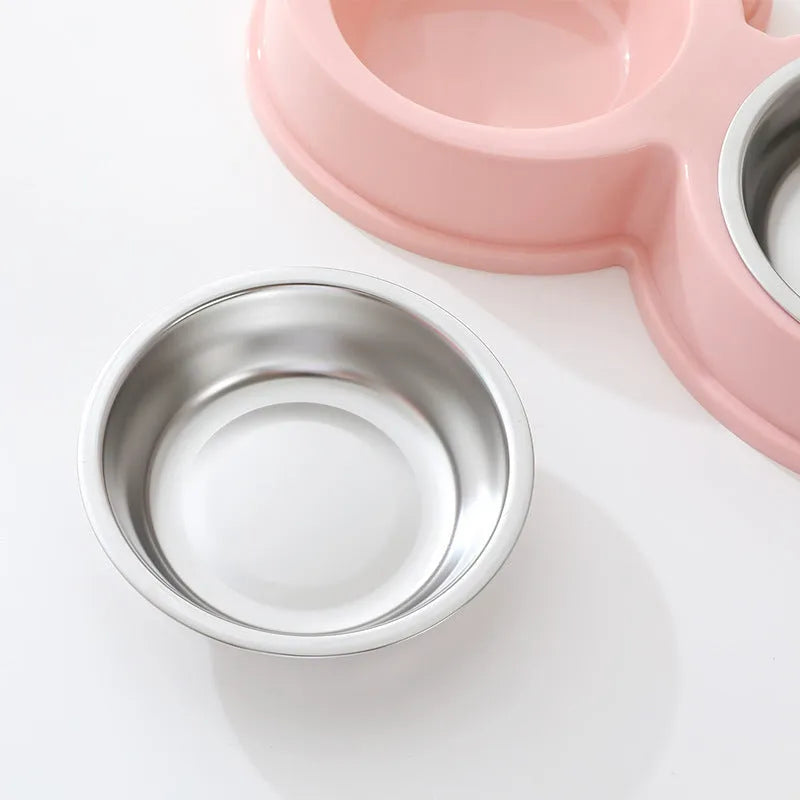 A stainless steel pet bowl with two compartments for water and food, shown in blue.