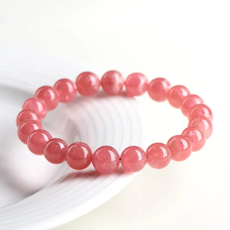 Women's geometric crystal bracelet with a red rhodochrosite stone and silver longevity lock clasp.
