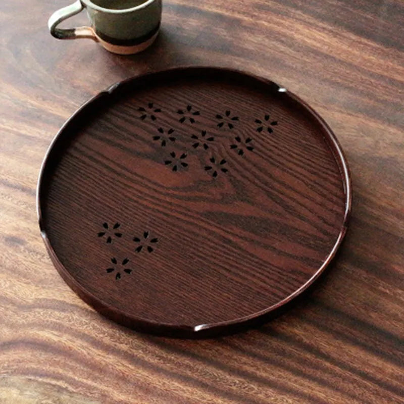 Wooden shallow serving plate with hollow cherry blossom design, 30 cm in diameter.