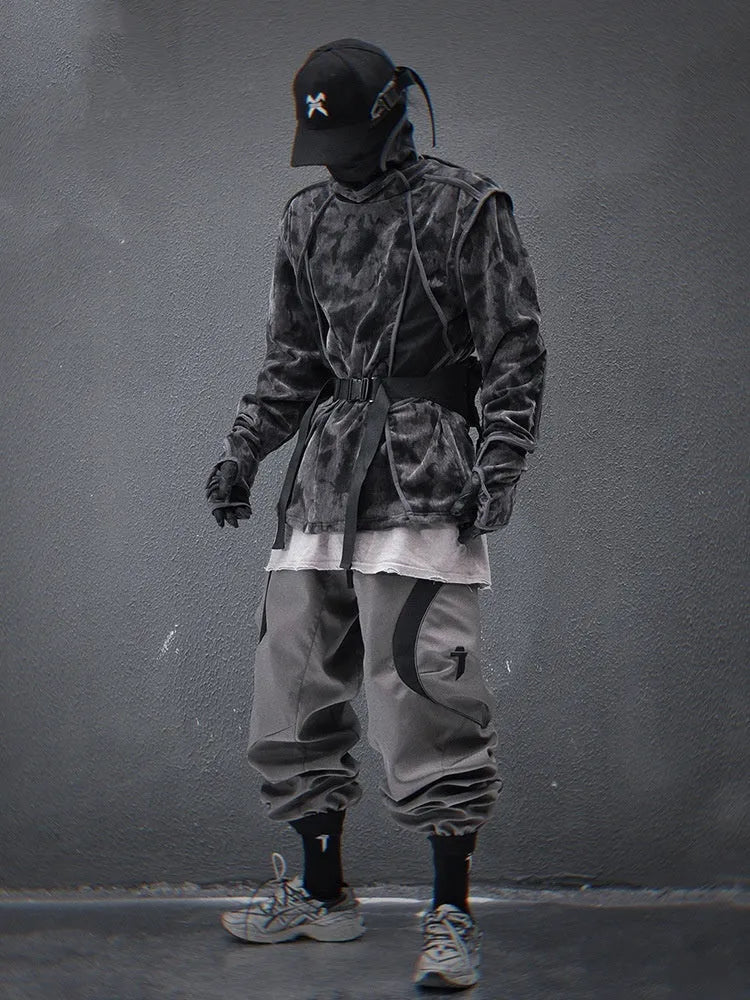 Man modelling a black and grey tie dye finger turtleneck sweater with drop shoulders.