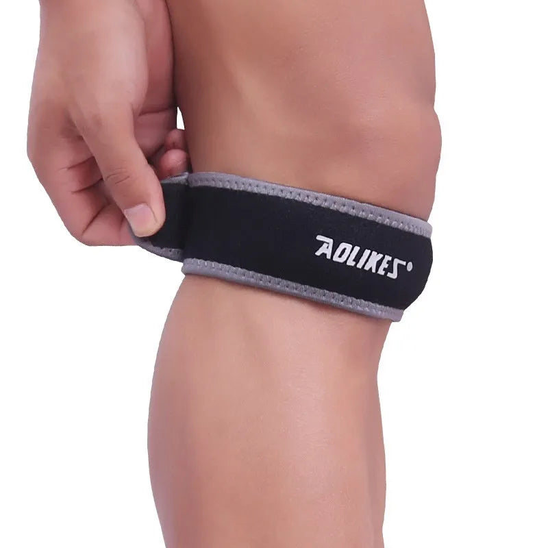 Black and grey adult patellar retinaculum knee brace for sports support.