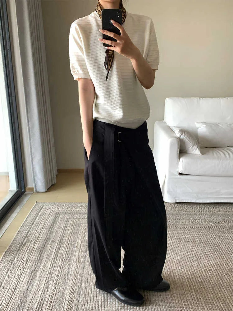 Black straight-leg trousers with a single pleat and adjustable waistband on a hanger