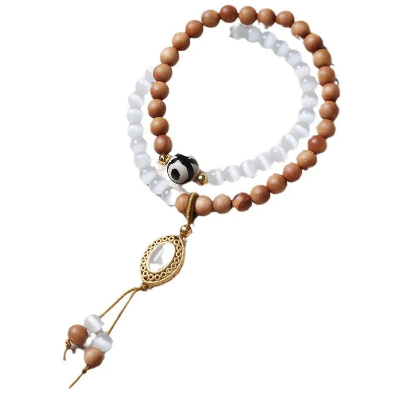 Mixed material bracelet with sandalwood double ring and opal Tibetan beads.