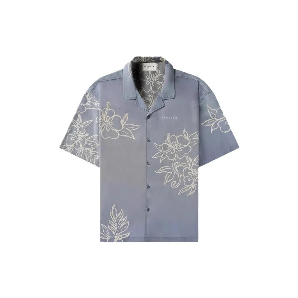 Man wearing a loose-fit, short sleeve floral print top in a neutral colour.