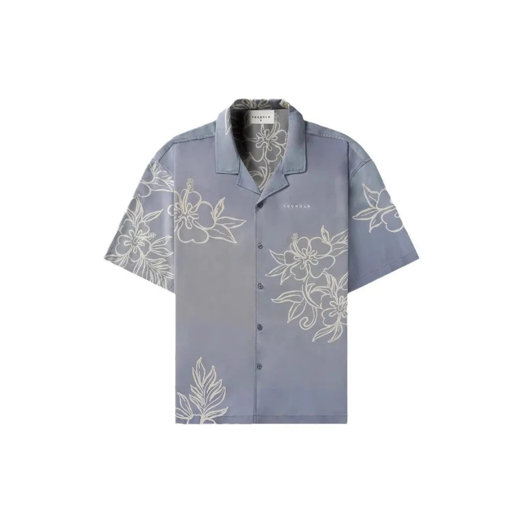 Man wearing a loose-fit, short sleeve floral print top in a neutral colour.
