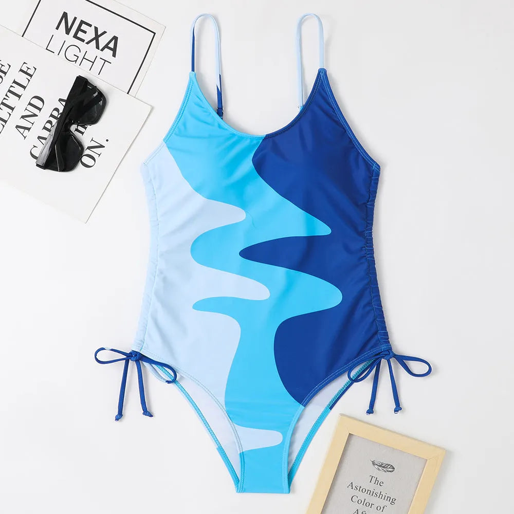 Women's sleeveless one-piece swimsuit in blue with backless design and striped pattern