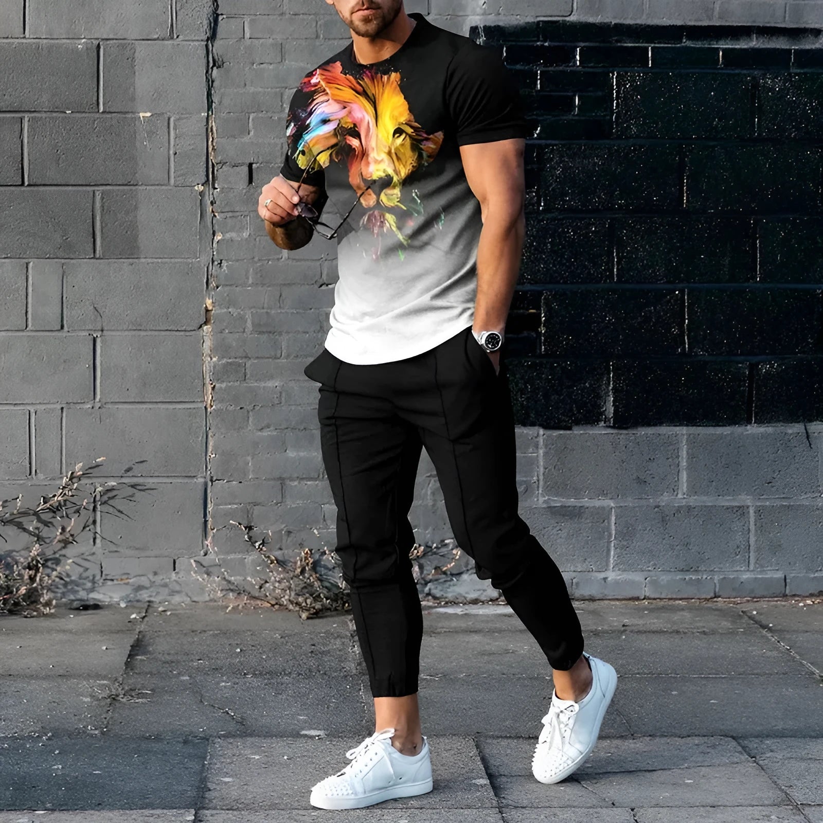 Man wearing a printed short-sleeve t-shirt and matching trousers from a cotton-like men's tracksuit set.
