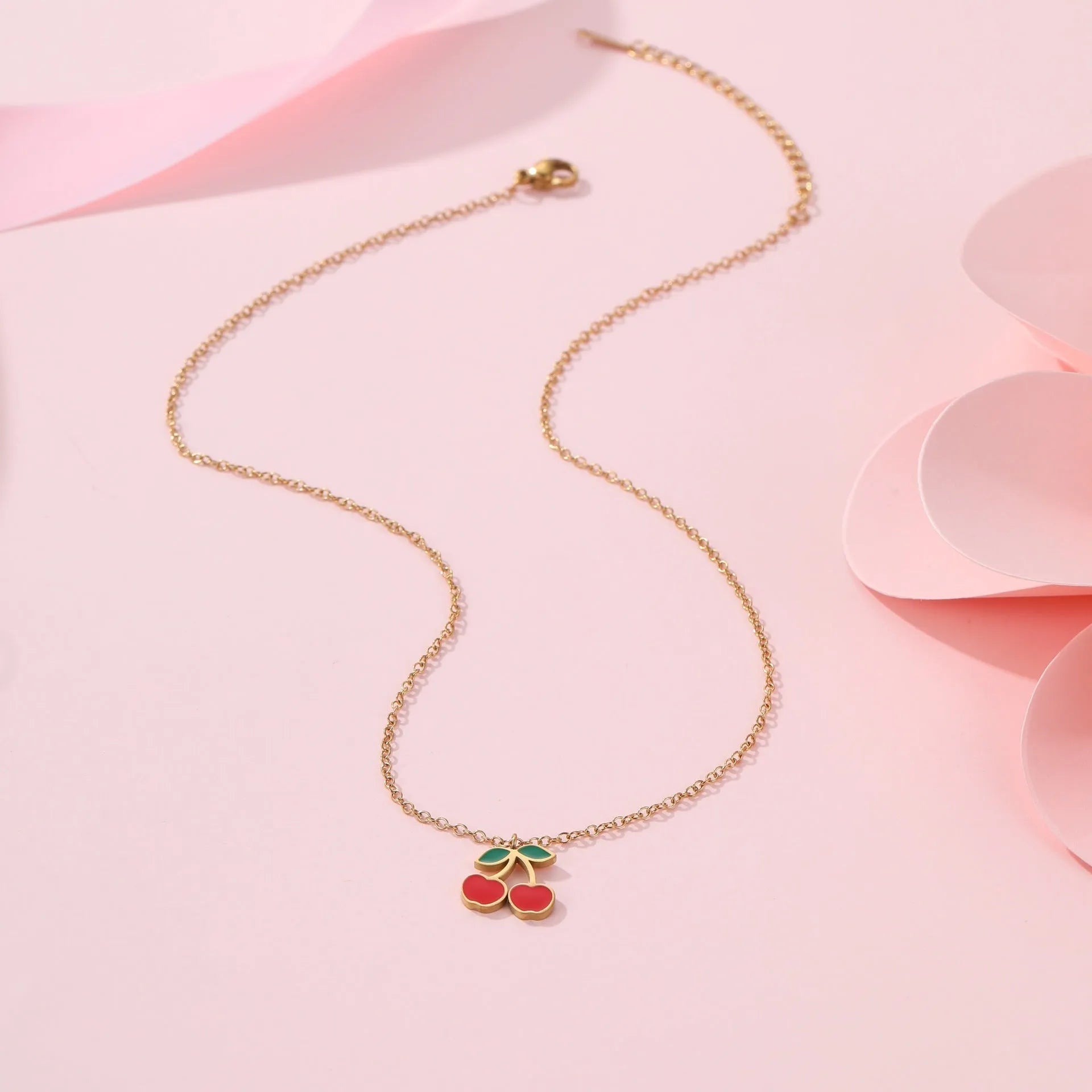 Cherry jewellery set with stainless steel necklace, bracelet, earrings, and ring featuring geometric shapes and 18K plating