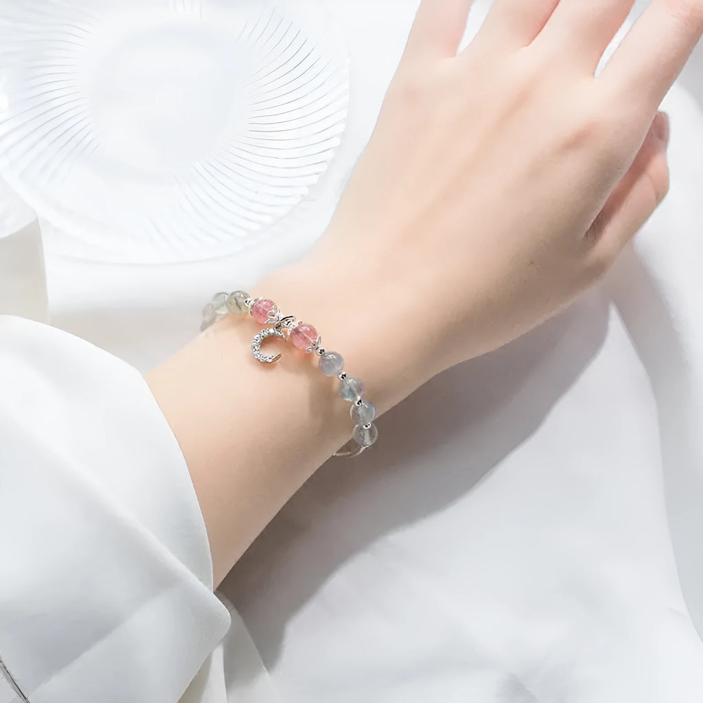 Handmade silver-tone adjustable bracelet with a 6mm moonstone bead and a small crescent moon charm.