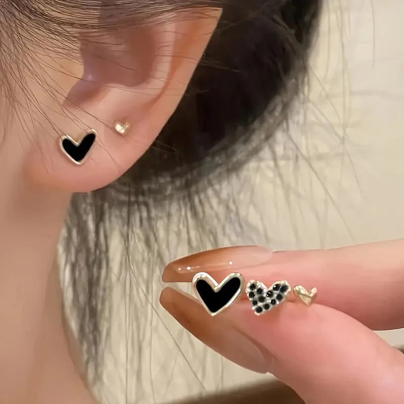 Three pairs of heart shape alloy earrings with electroplated gold, black, pink, and black-white colour options
