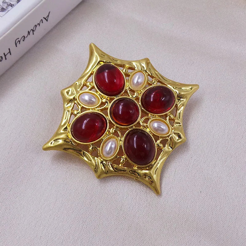 Close-up of vintage medieval baroque cross brooch with crystal details on zinc alloy base