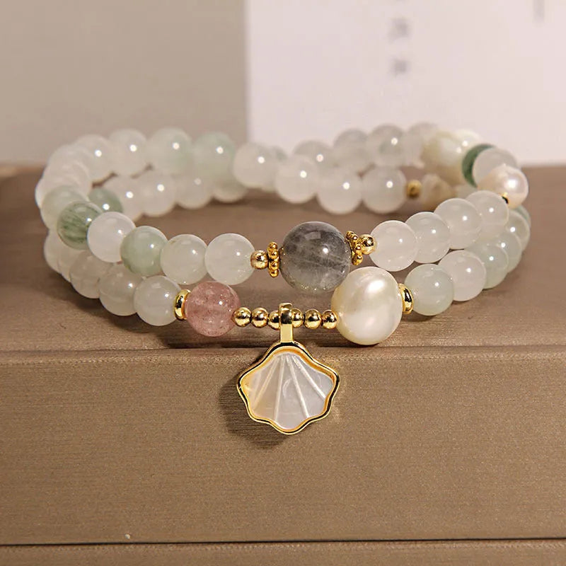 Women's crystal bracelet with an apricot leaf and jade shell pendant, gold-plated settings, and rhinestones.