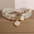 Women's crystal bracelet with an apricot leaf and jade shell pendant, gold-plated settings, and rhinestones.
