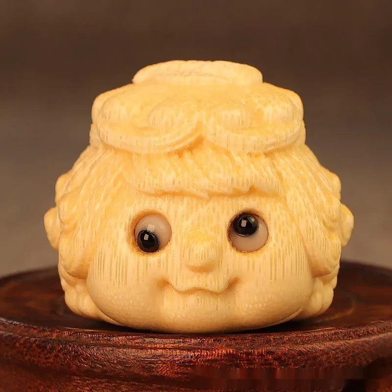 Solid bamboo golden toad princess ornament on a surface