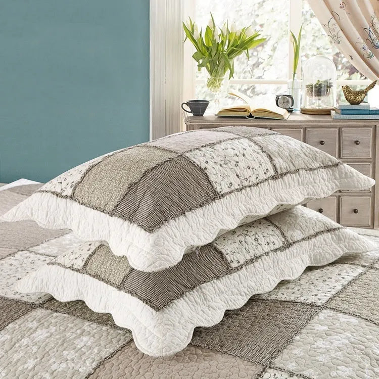 Washed pure cotton quilted bedspread set with one large cover and two pillowcases on a bed.