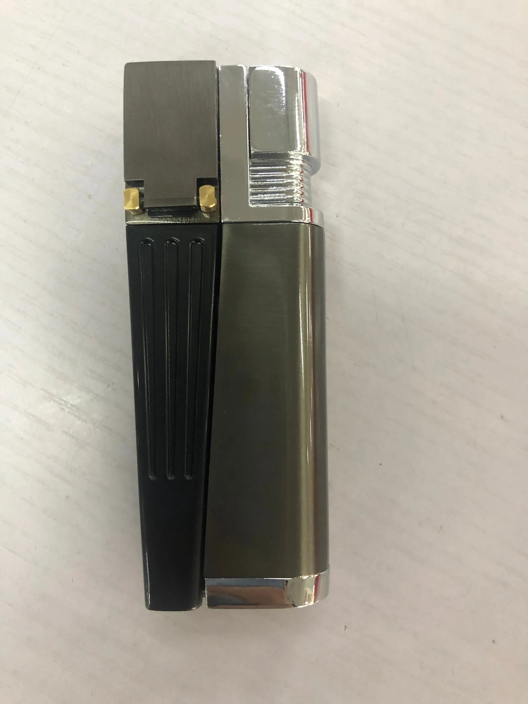 Folding metal pipe lighter showing open position with stash compartment visible